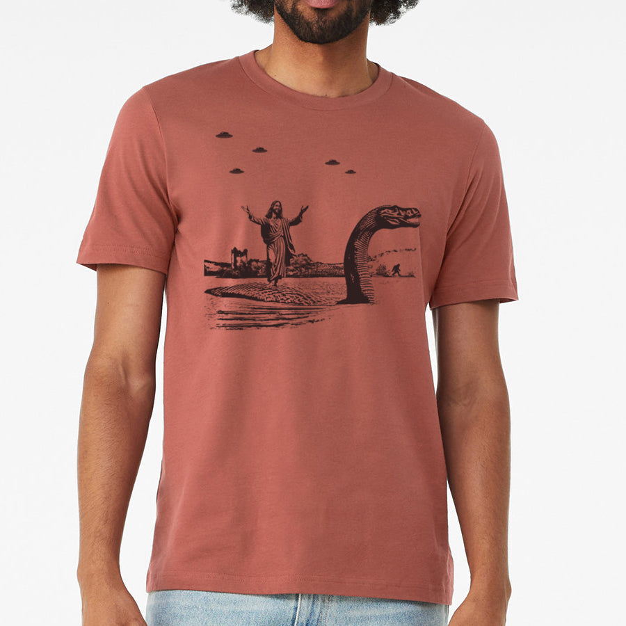 Jesus Christ Riding The Loch Ness Monster Men's Tshirt | Guys Funny Dinosaur Tee | Humorous Religious Tee with Jesus and Nessie